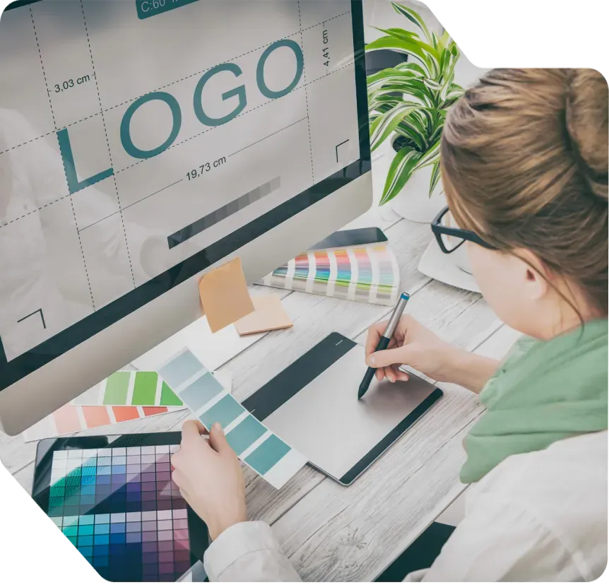 Graphic designer creating a logo using color palettes and digital design tools